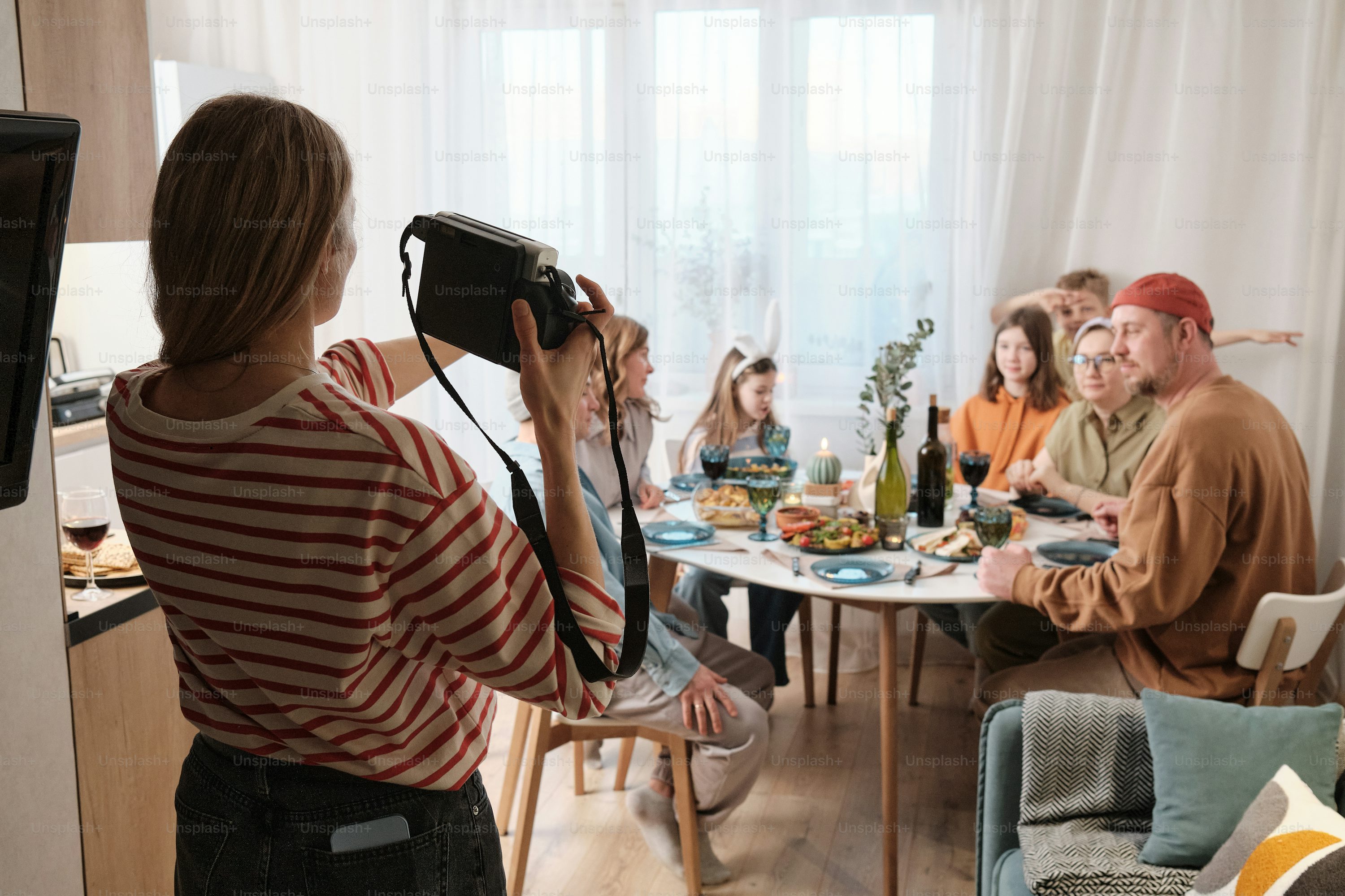Friends sharing a meal indoors, illustrating a home gathering